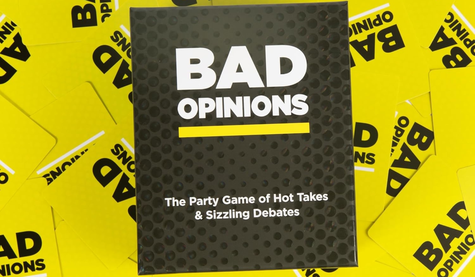 The game Bad Opninions with yellow game cards around it with funny bad opinions on it